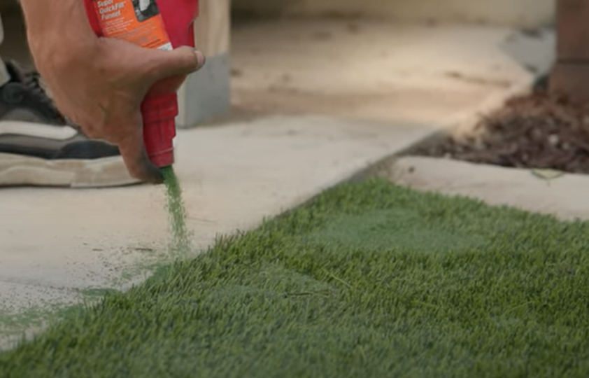 Putting down turf infill for our turf maintenance and cleaning service.