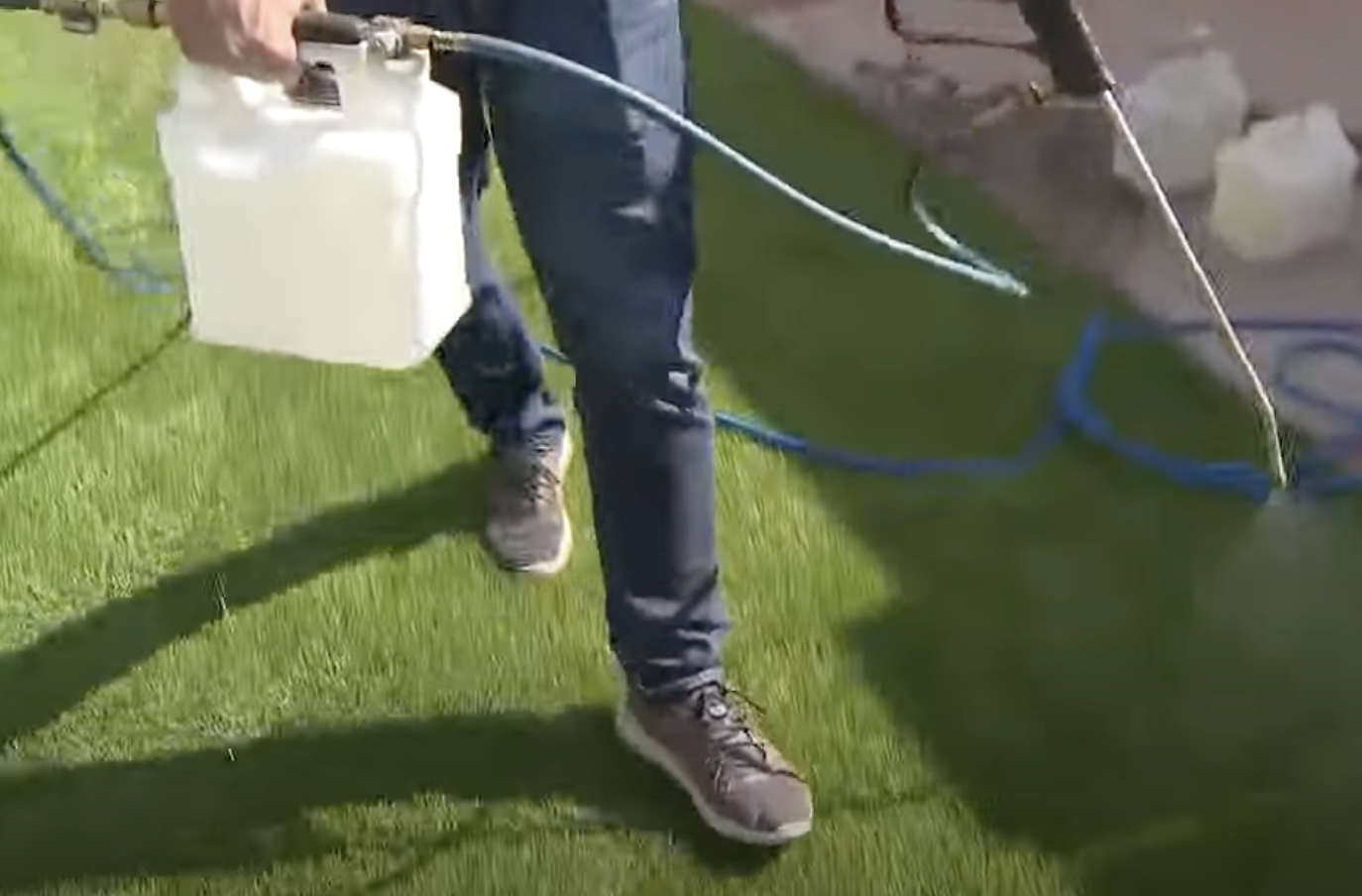 Removing pet urine odor from a turf in Las Vegas using spray.